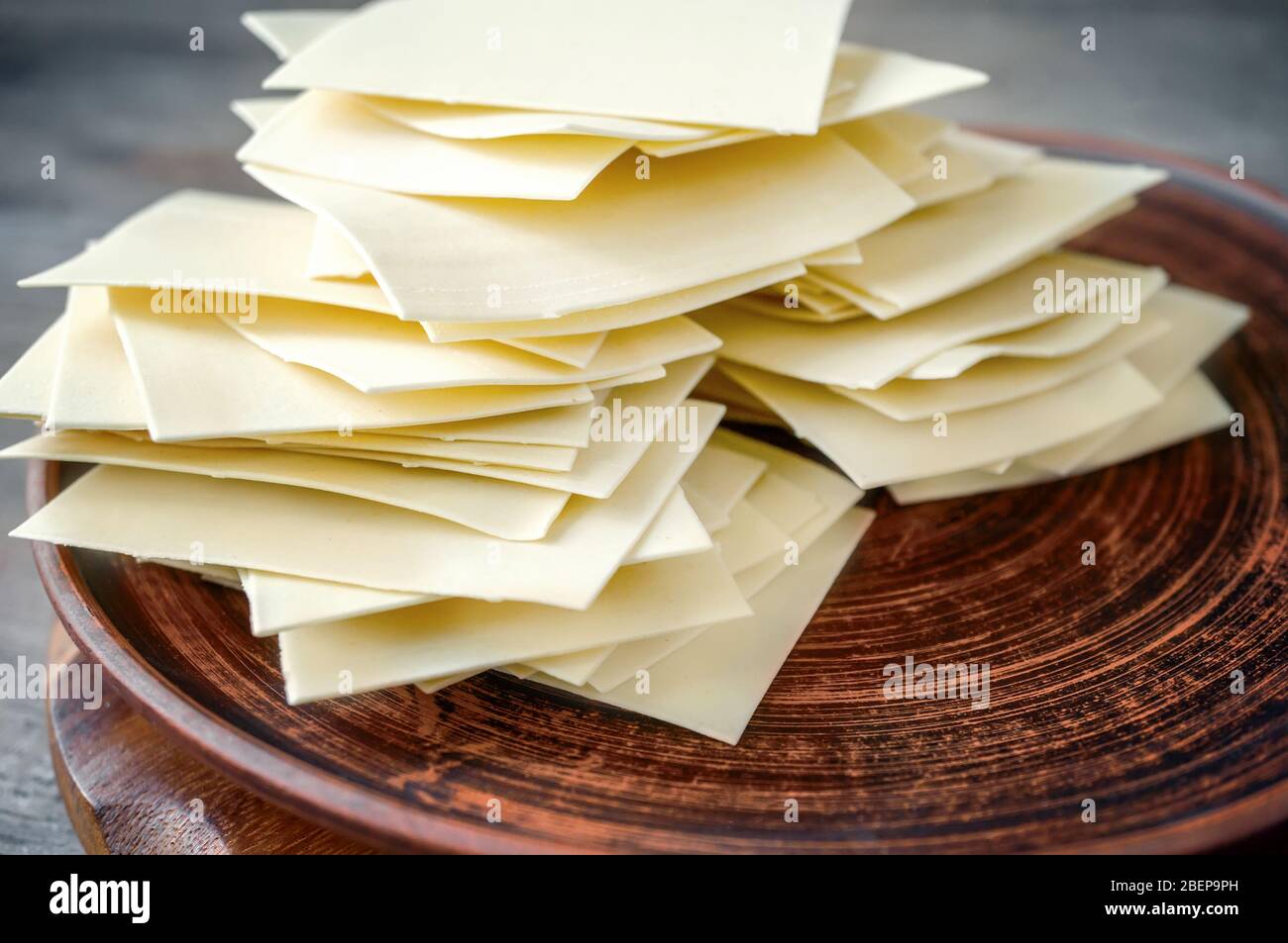 Ready-made dried dough squares for lasagna and beshbarmak. Sheets and thin layers of dough for national dishes. Stock Photo