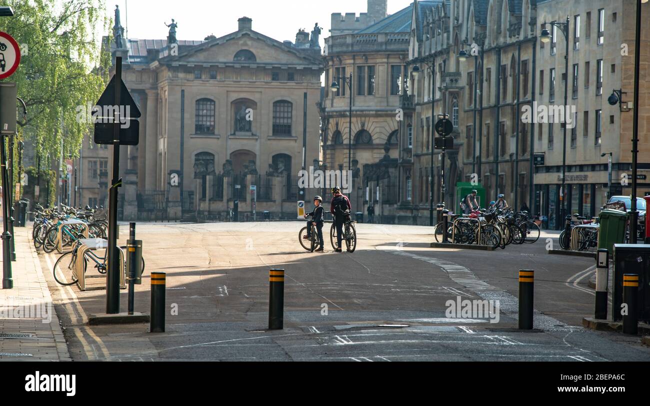 Oxford, Oxfordshire, UK. Deserted streets on a sunny Easter Sunday. A few cyclists and people taking other exercise are out,  PICTURED: Broad Street Stock Photo