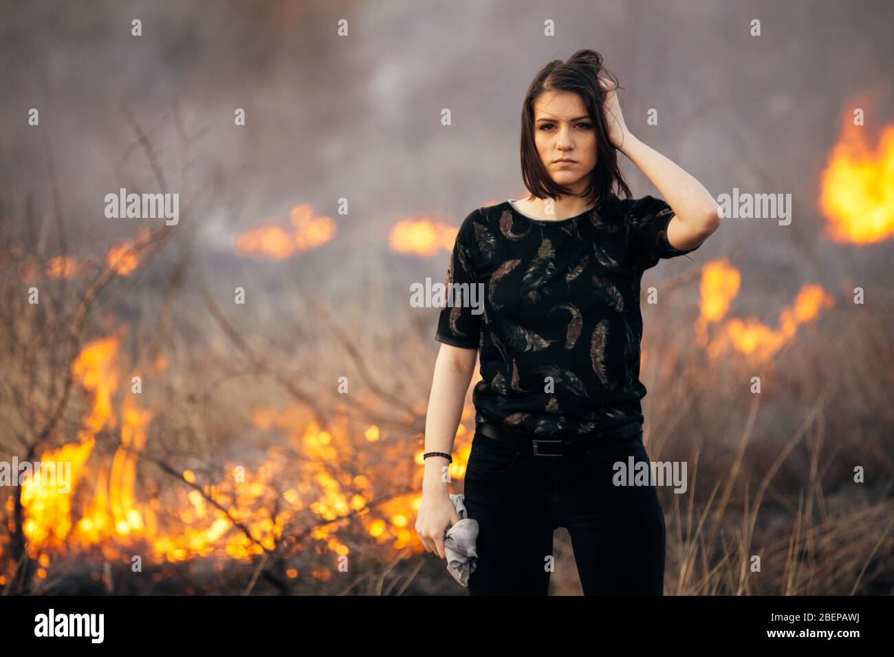 Riots, terrorism, aggression, violence, arson, mayhem,protest concept.Disaster in bush forest with fire spreading in dry woods caused by pyromaniac.Va Stock Photo