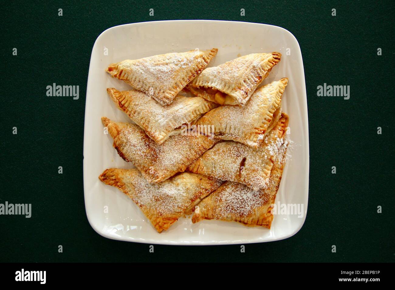 Homemade apple turnover with icing sugar. Stock Photo