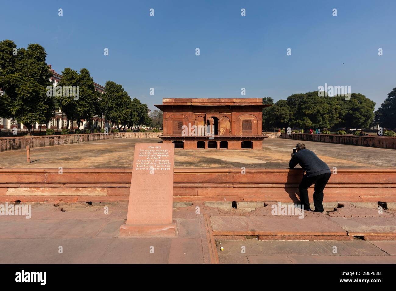 A tourist takes a photo inside the famous Red Fort in the district of Shahjahanabad in Delhi, India Stock Photo