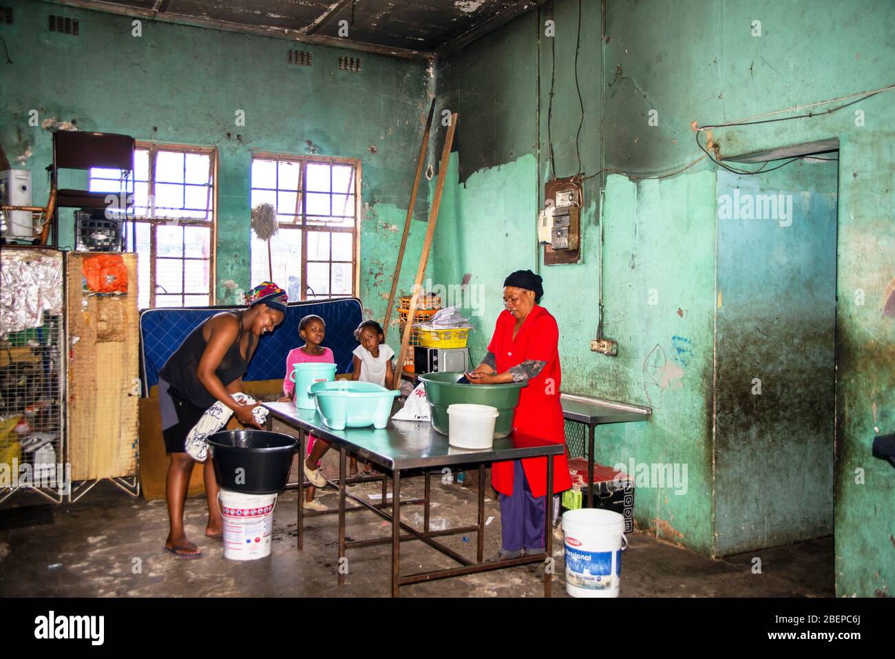 Women wash their clothes in a communal laundry room in the Langa township near Cape Town. The Women wash their clothes in a communal laundry room in the Langa township near Cape Town. The
