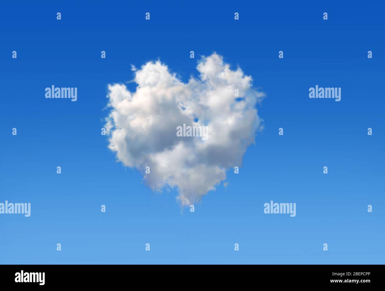 Fluffy cloud with the shape of a heart in a blue sky as love sign. Stock Photo