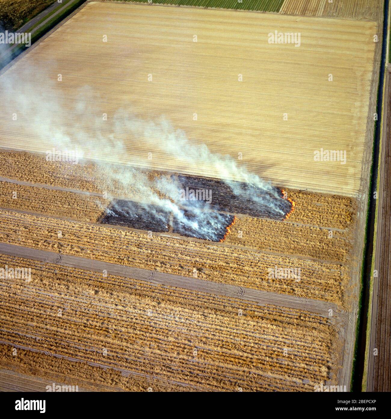 Zijpe, Holland, April 14 - 1988: Historical aerial photo of controlled burning down the agriculture fields in springtime in the northern part of Holla Stock Photo