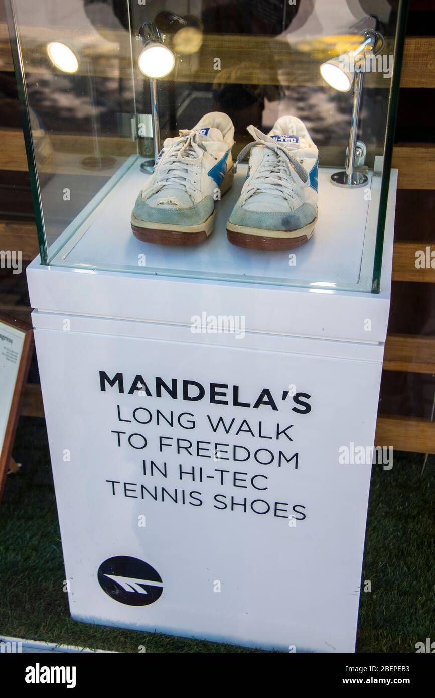 The late South African president and global icon of freedom, affectionately known as Madiba, walked out of the notorious Robben Island prison in 1990 after a total of 27 years of incarceration and hard labour wearing a pair of white tennis shoes, U.S. size 10, with the Hi-Tec logo in blue. The photo is taken from the public pavement in front of the shop. Stock Photo