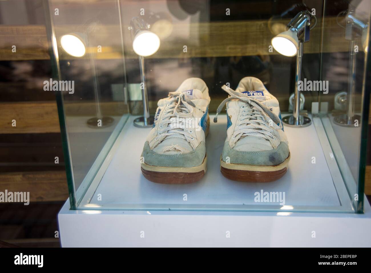 The late South African president and global icon of freedom, affectionately known as Madiba, walked out of the notorious Robben Island prison in 1990 after a total of 27 years of incarceration and hard labour wearing a pair of white tennis shoes, U.S. size 10, with the Hi-Tec logo in blue. The photo is taken from the public pavement in front of the shop. Stock Photo