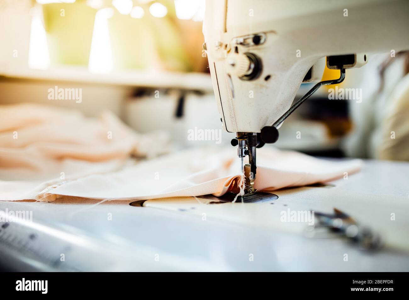 Sewing machine.Handmade reusable non-medical cloth fabric coverings,coronavirus protective cotton masks making.Face mask guidance.DIY masks,learning h Stock Photo