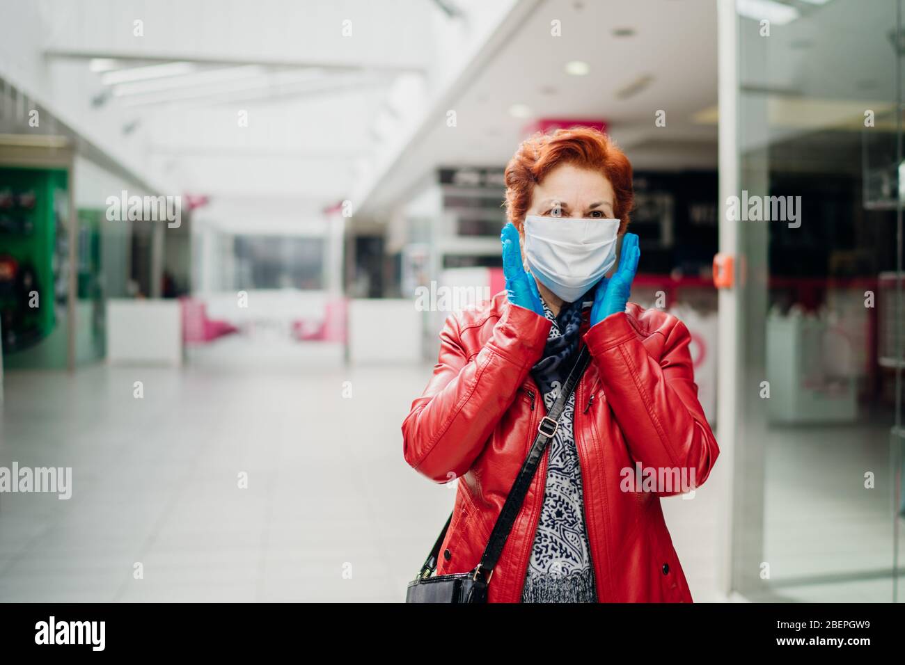 Senior elderly woman with protective cloth face mask and gloves. Coronavirus COVID-19 outbreak elder disease infection protection. Retired grandmother Stock Photo