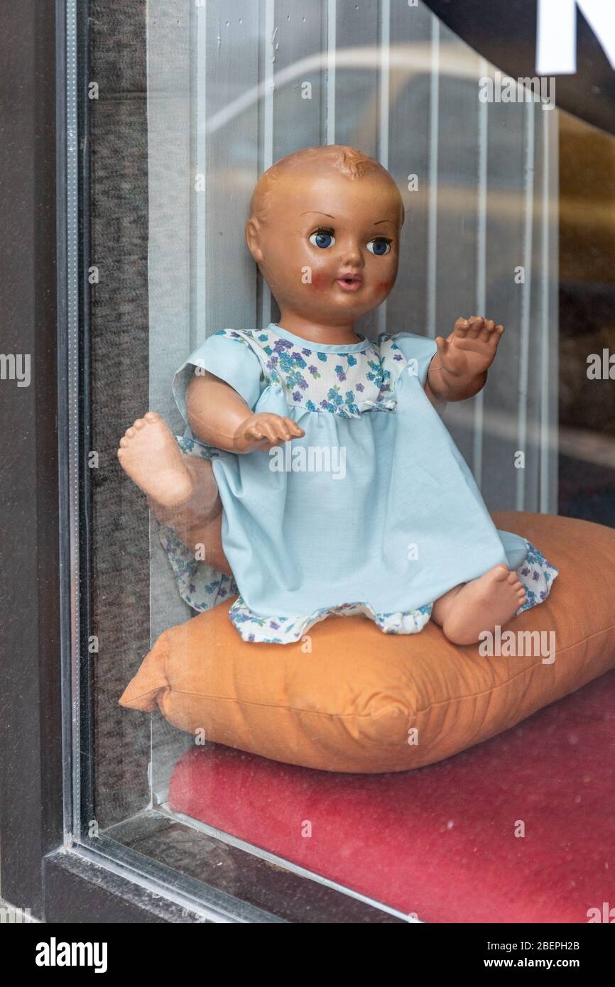 Baby doll in a bar window during coronavirus lockdown in Helsinki, Finland Stock Photo