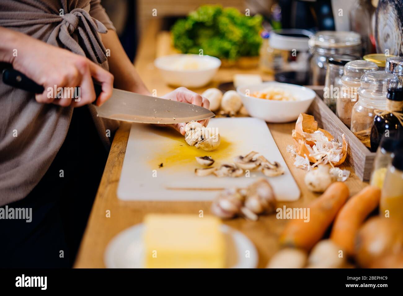 Housewife woman cutting fresh vegetables.Ingredients for cooking food with mushrooms.Healthy food for strong immune system.Health benefits.Preparing v Stock Photo