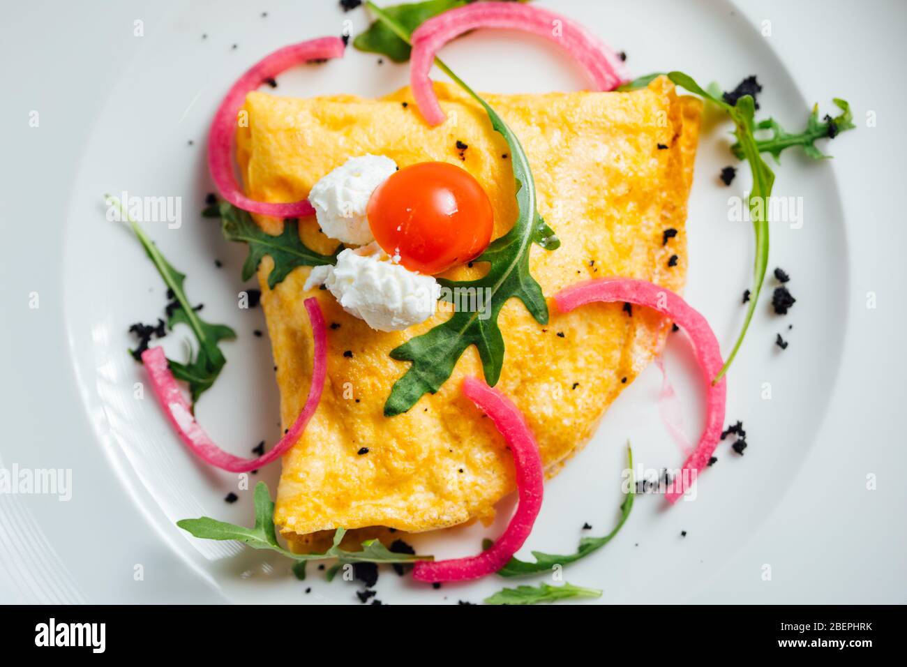 Homemade beaten eggs soft omelette.Colorful healthy breakfast at home.Home cooked meal served.Low calorie food,low carb lifestyle eating in.Keto meal. Stock Photo