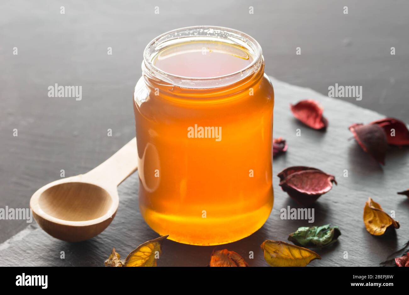Honey jar without lid on black background with copy space Stock Photo