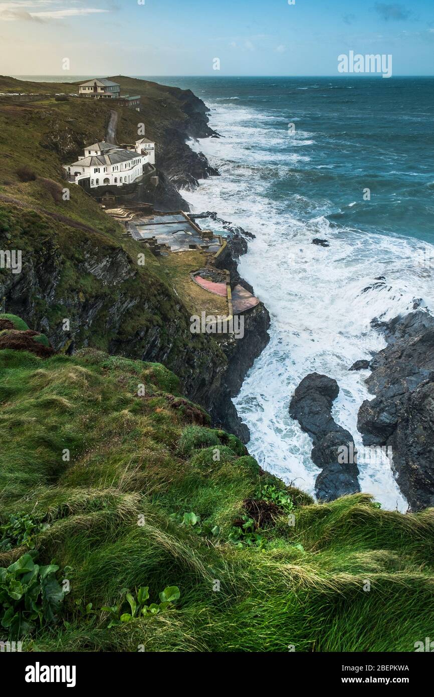 The large house known as Bakers Folly with the Lewinnick Lodge in the background on the rugged coast of Pentire Point East in Newquay in Cornwall. Stock Photo