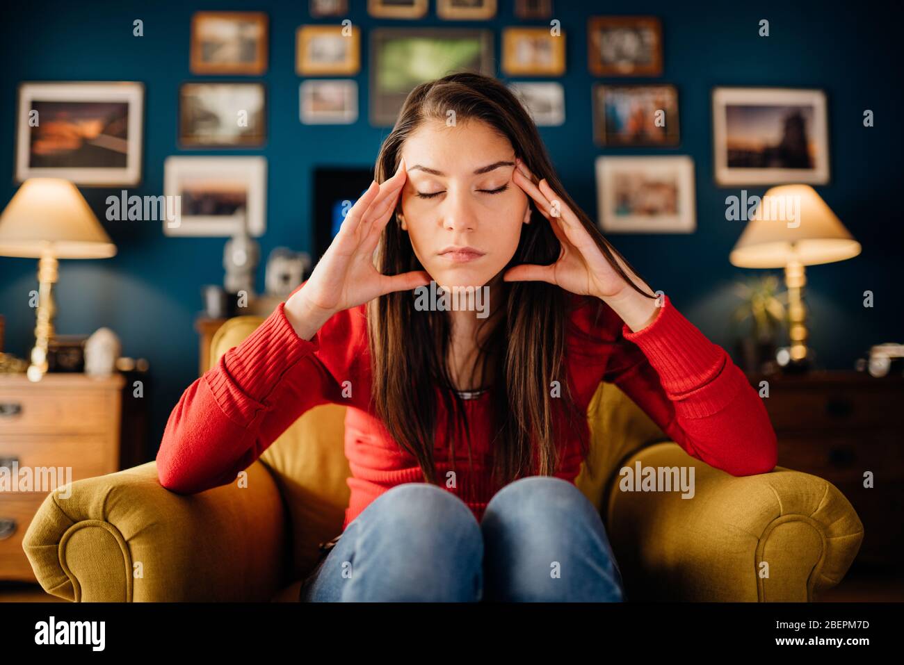 Stressed woman overthinking events alone at home.Thinking of problems.Concentration problems.Brain/cognitive/neurological activity stimulation.Memory Stock Photo