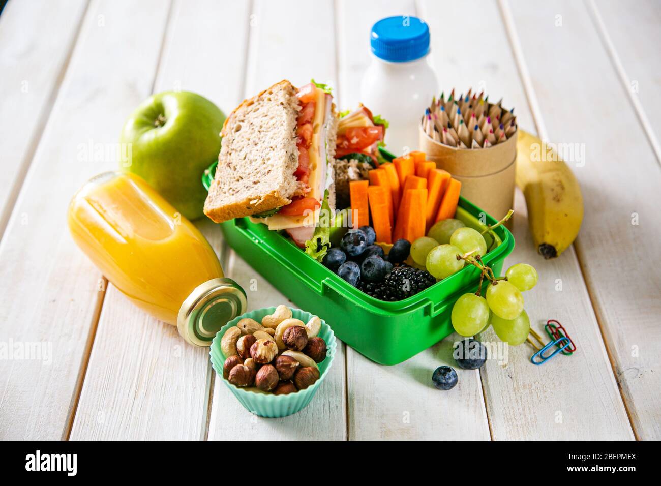 Back to school concept lunch box with juice, apple and banana Stock