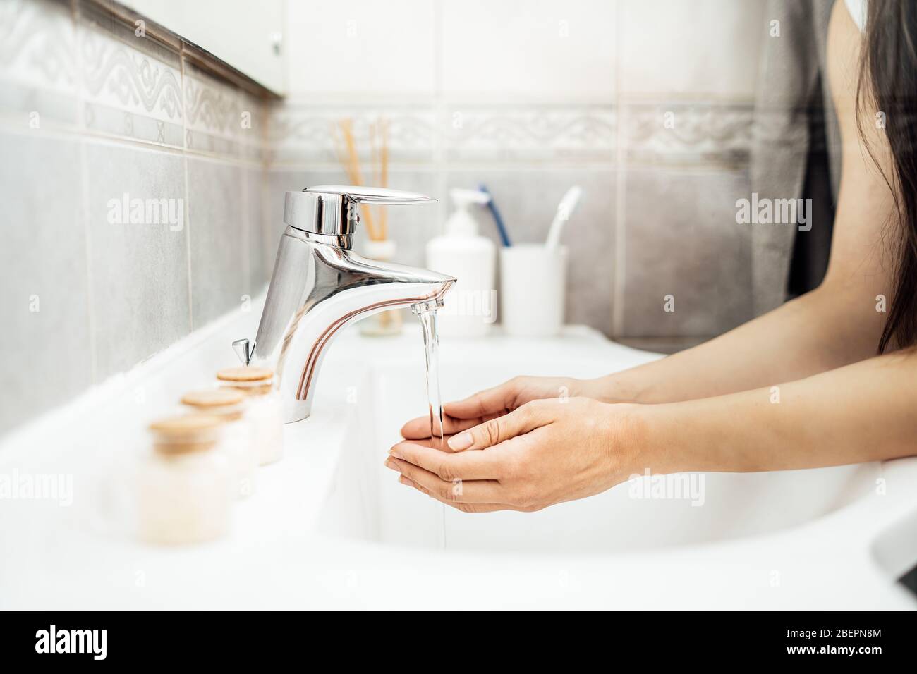 Antiseptic hand washing practice with soap and water in bathroom.Decontamination procedure,personal hygiene routine.Cleaning hands regularly. Stock Photo