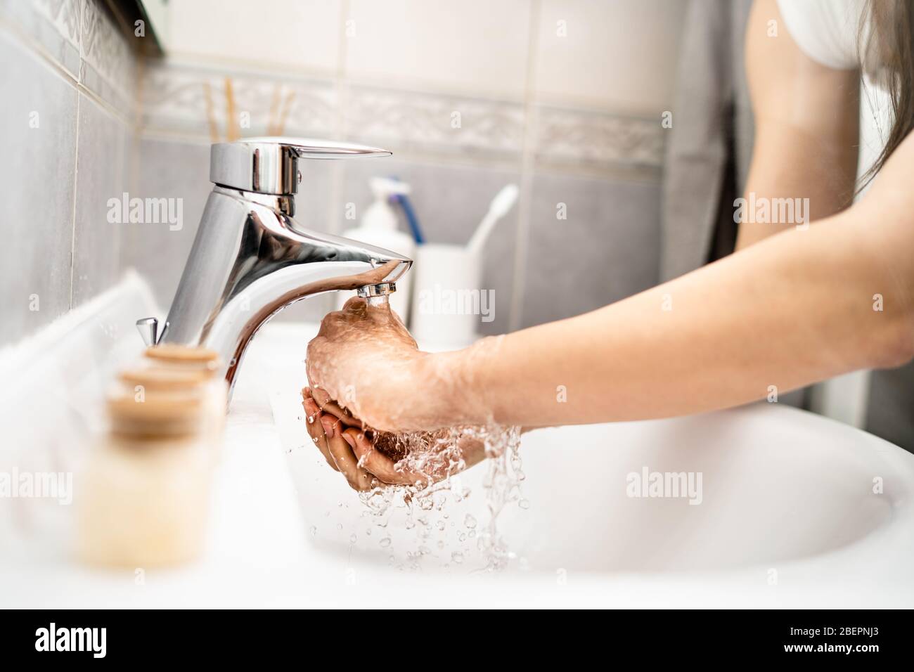 Woman washing hands with soap and water in clean bathroom.Decontamination protocol, hand hygiene routine. Cleaning hands regularly. Infectious disease Stock Photo