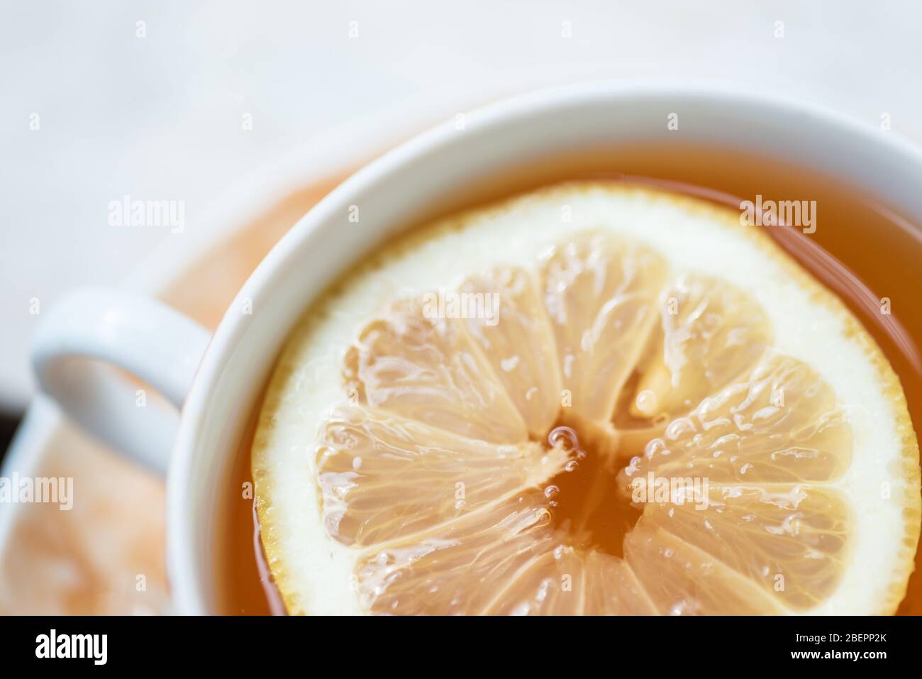 crockery cup of fresh prepared black tea with slice of lemon Stock Photo