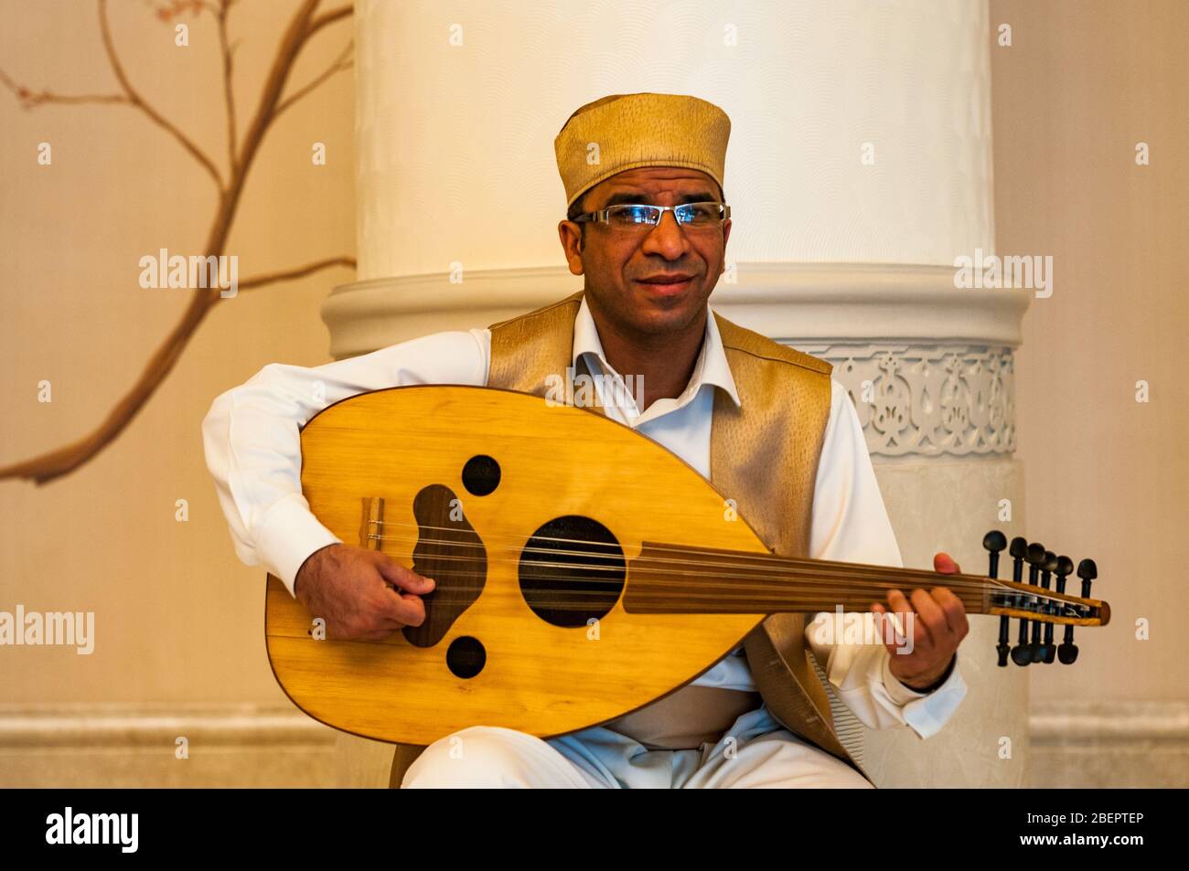A musician plays an oud a traditional stringed instrument in the