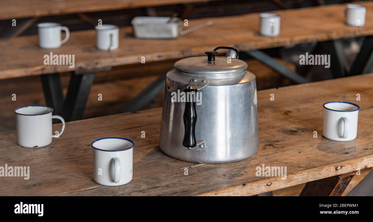 Tea pot and mugs on workers canteen table Stock Photo Alamy