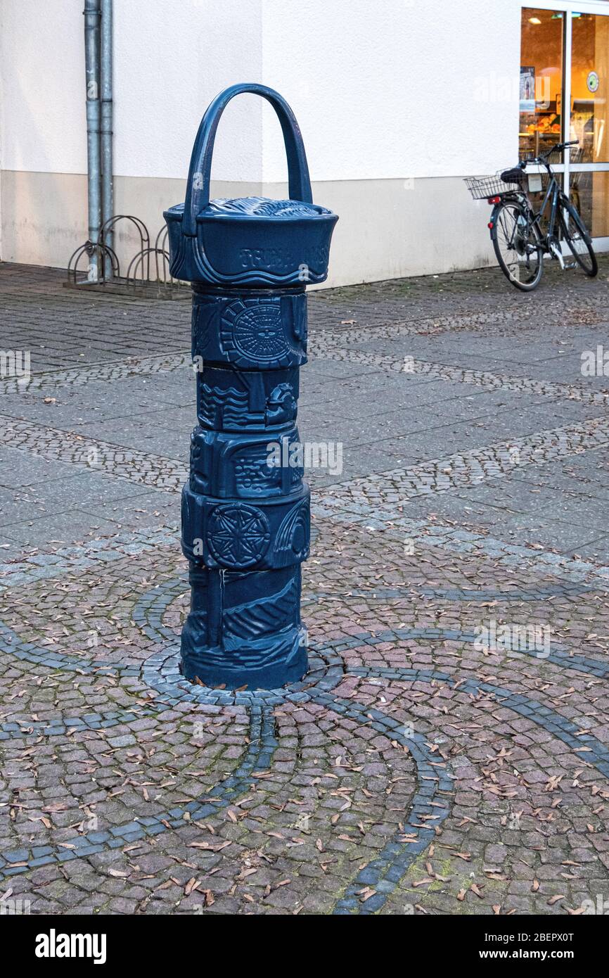 Old blue metal water fountain on cobbled pavement in Rudow-Berlin, Neukölln, Germany Stock Photo