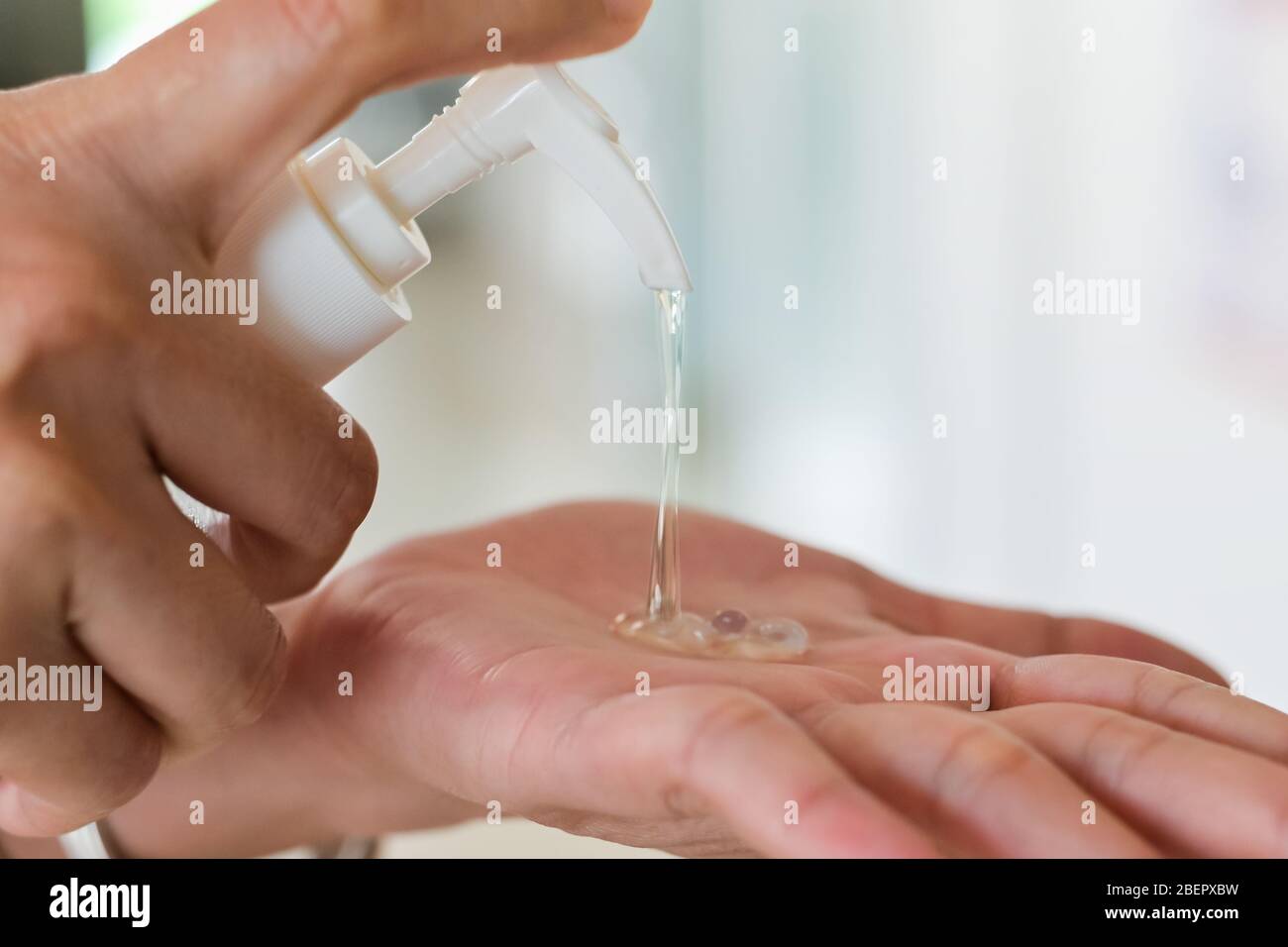 Hand sanitizer,Close up Woman hands using wash hand sanitizer gel dispenser prevention coronavirus Stock Photo