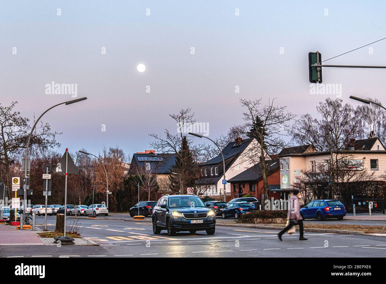 Street viewing suburbia  as the moon rises in Rudow-Berlin, Neukölln, Germany Stock Photo