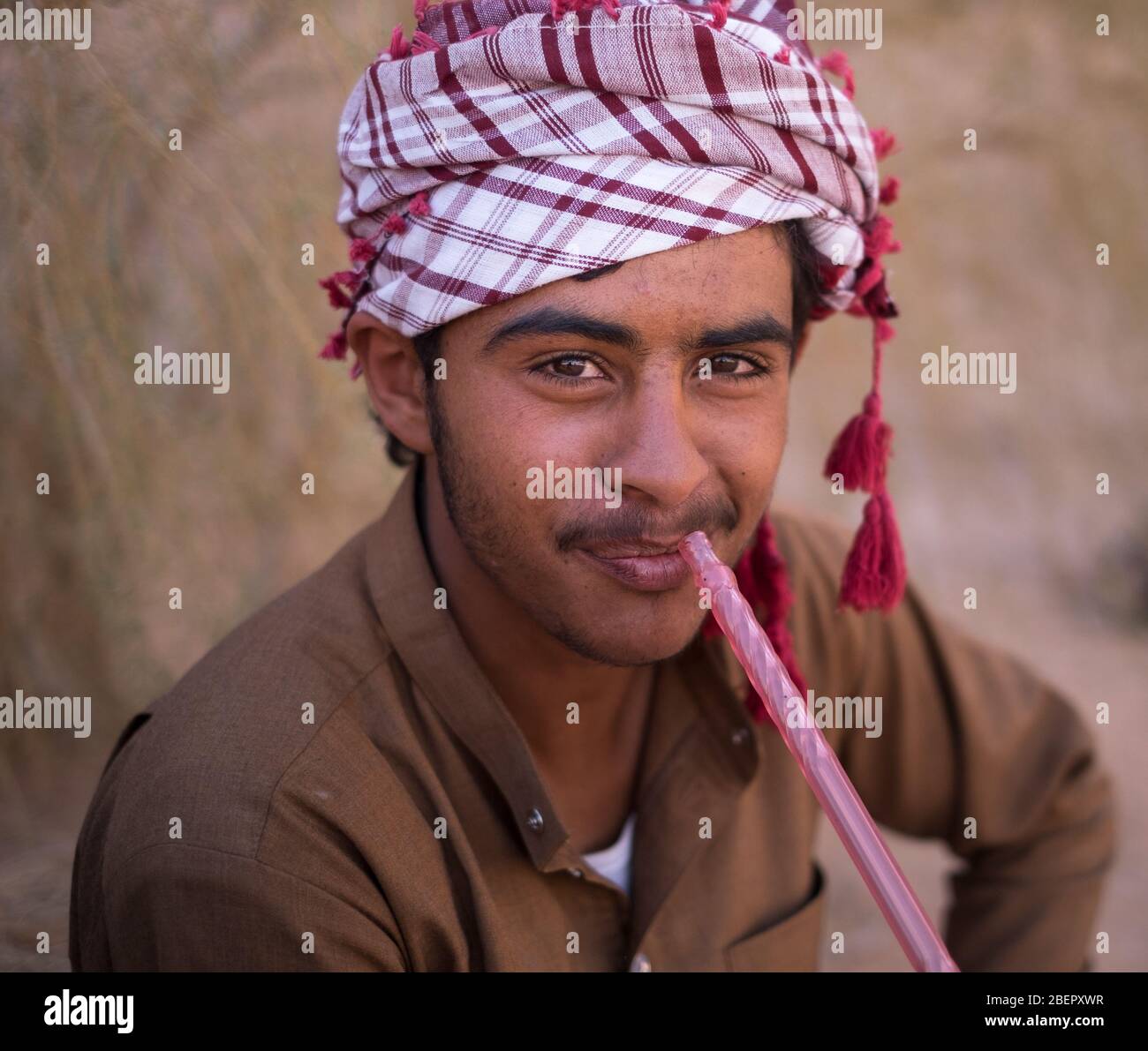Portrait of a local Bedouin smoking a shisha pipe in Wadi Rum, Petra Stock Photo