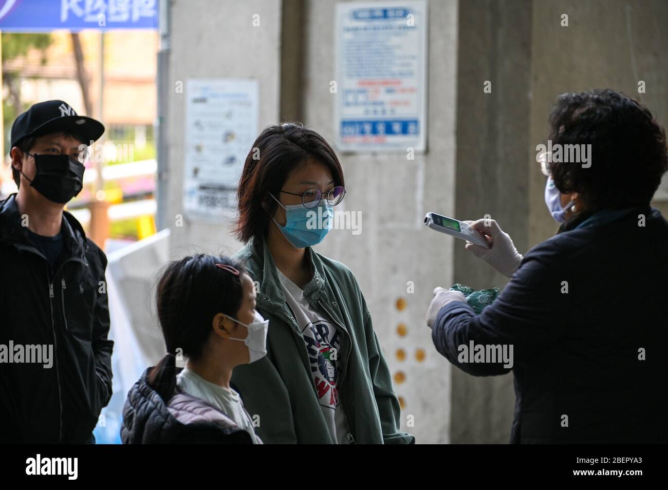 Seoul, South Korea. 15th Apr, 2020. A poll worker takes a voter's temperature before she enters a polling station in Seoul to vote in South Korea's parliamentary elections on Wednesday, April 15, 2020. Voters are to elect the country's 300-member National Assembly as South Korea and the world battles the coronavirus COVID-19. Photo by Thomas Maresca/UPI Credit: UPI/Alamy Live News Stock Photo