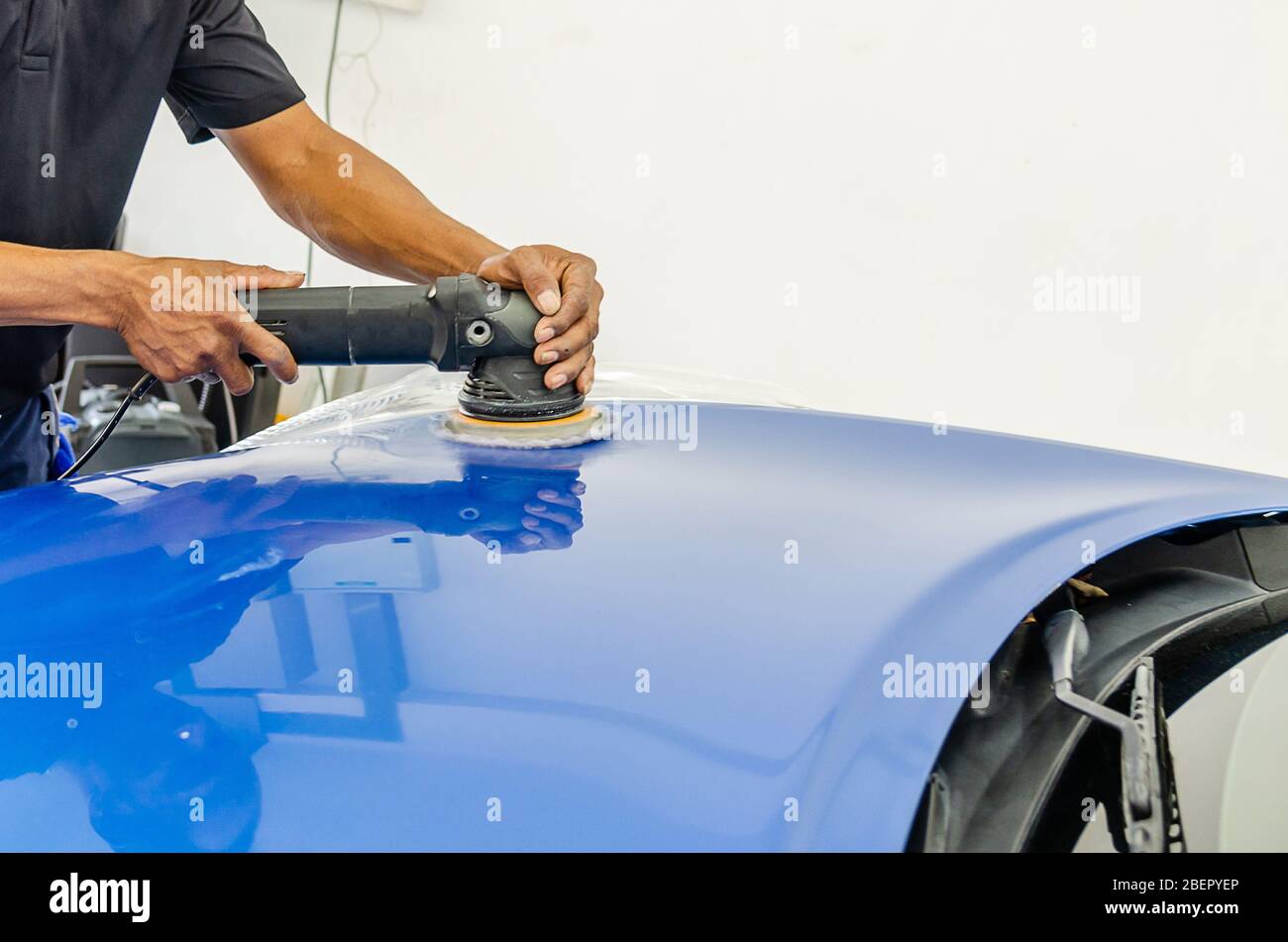 Auto polishing with machine.Blue car polish to remove and recover the