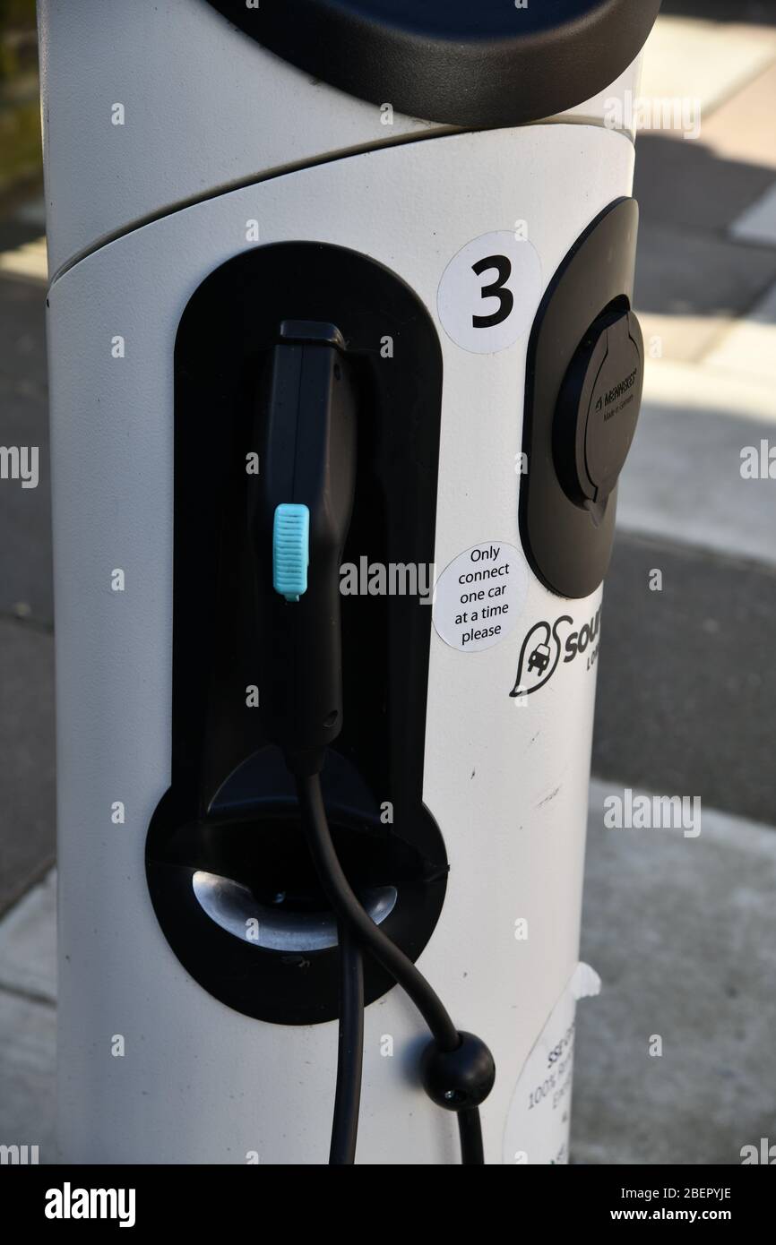 Tesla electric car at charging point on residential street Stock Photo ...