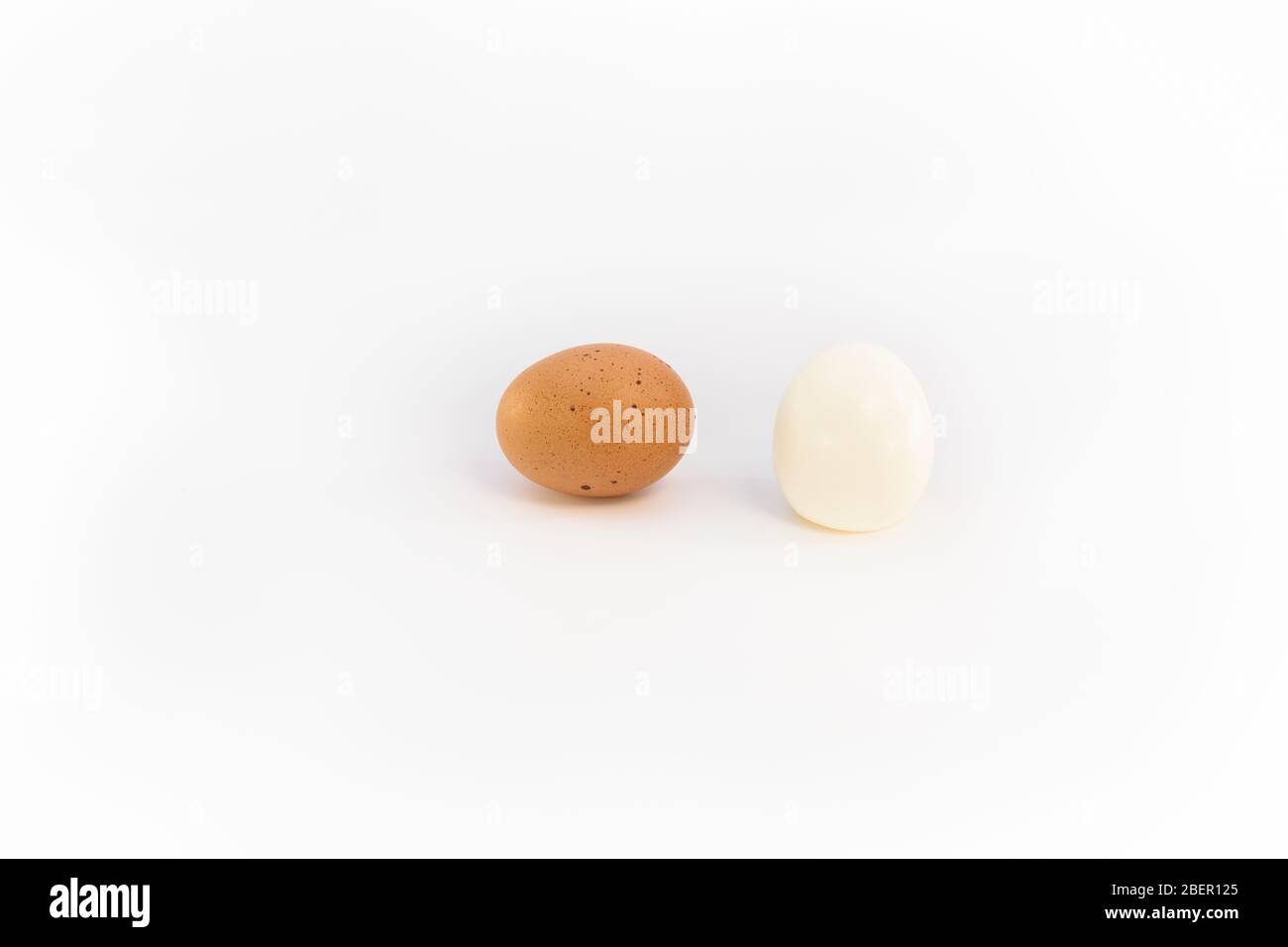 a brown chicken egg and an eggs boiled and peeled Stock Photo Alamy