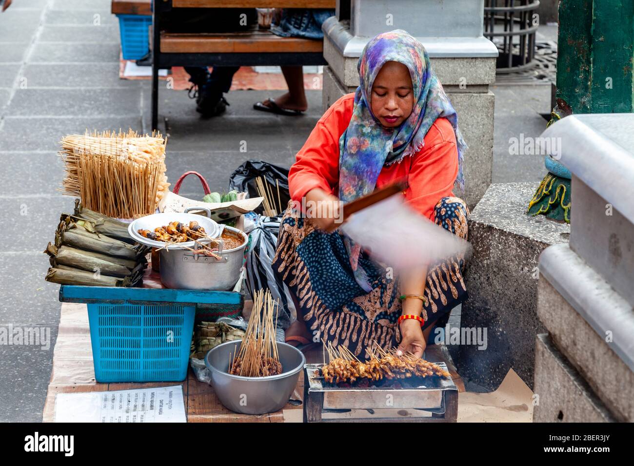 An Indonesian Woman Selling Snacks In Malioboro Street, Yogyakarta, Indonesia. Stock Photo