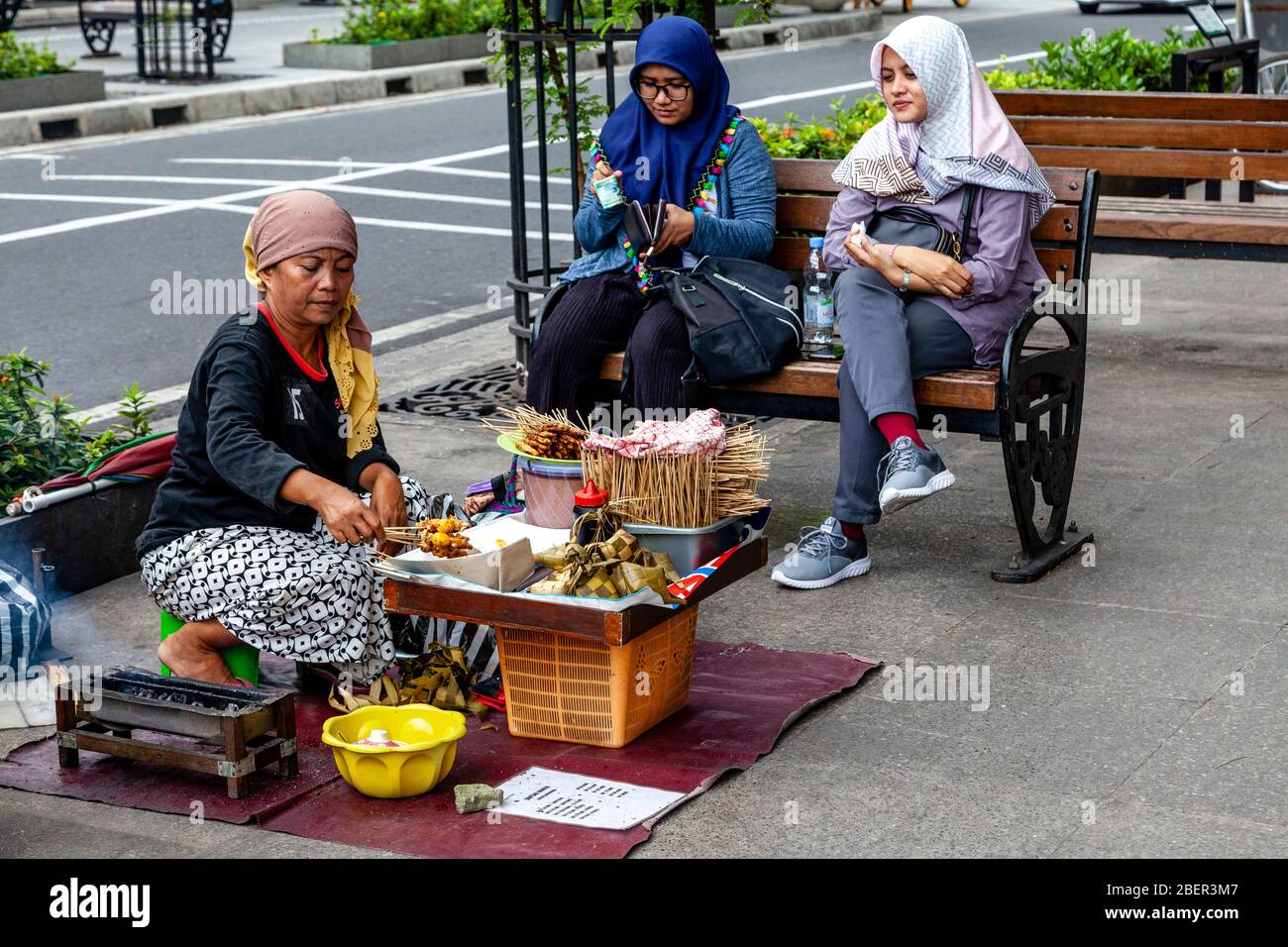 An Indonesian Woman Selling Snacks In Malioboro Street, Yogyakarta, Indonesia. Stock Photo