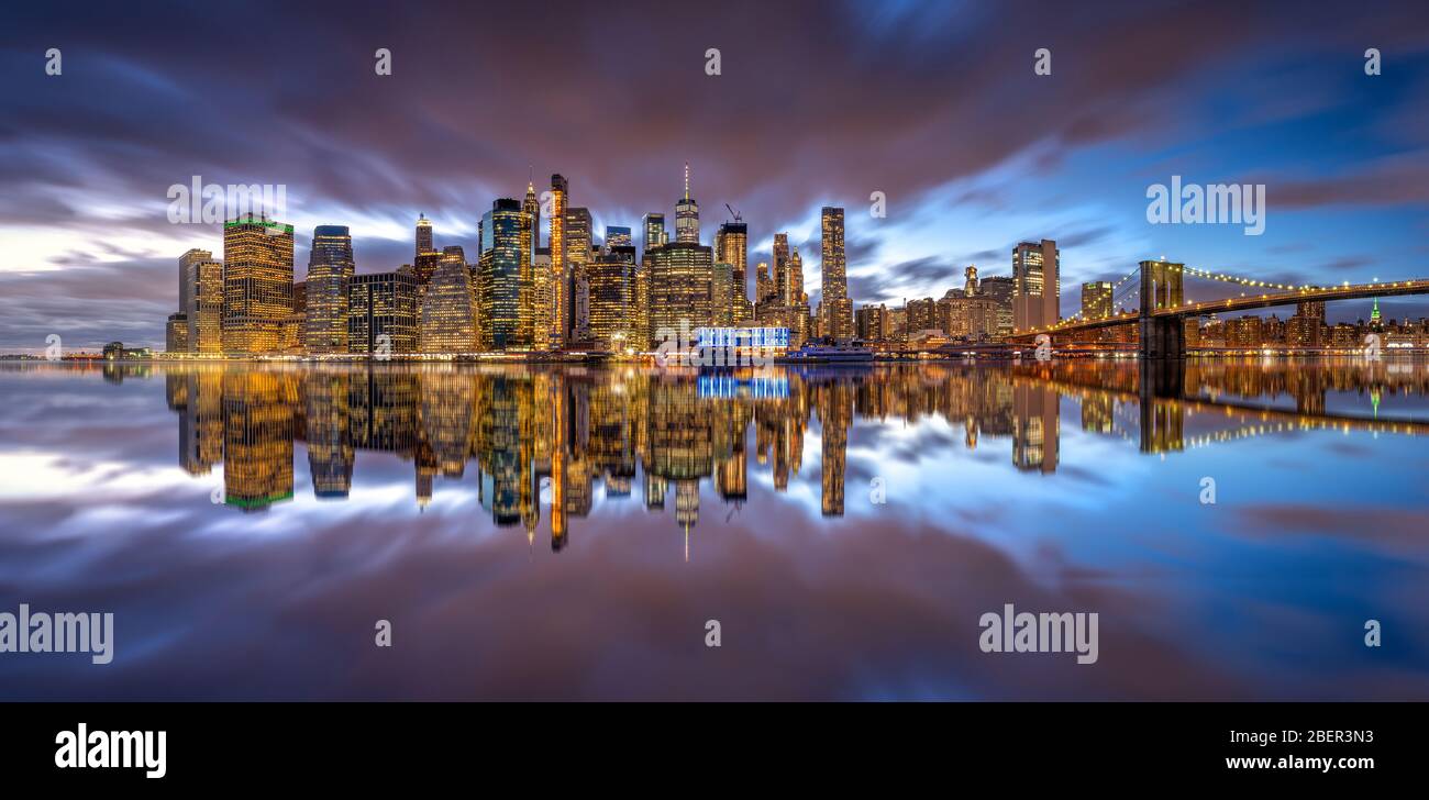 New york skyline reflection on the Hudson river at Brooklyn bridge at ...