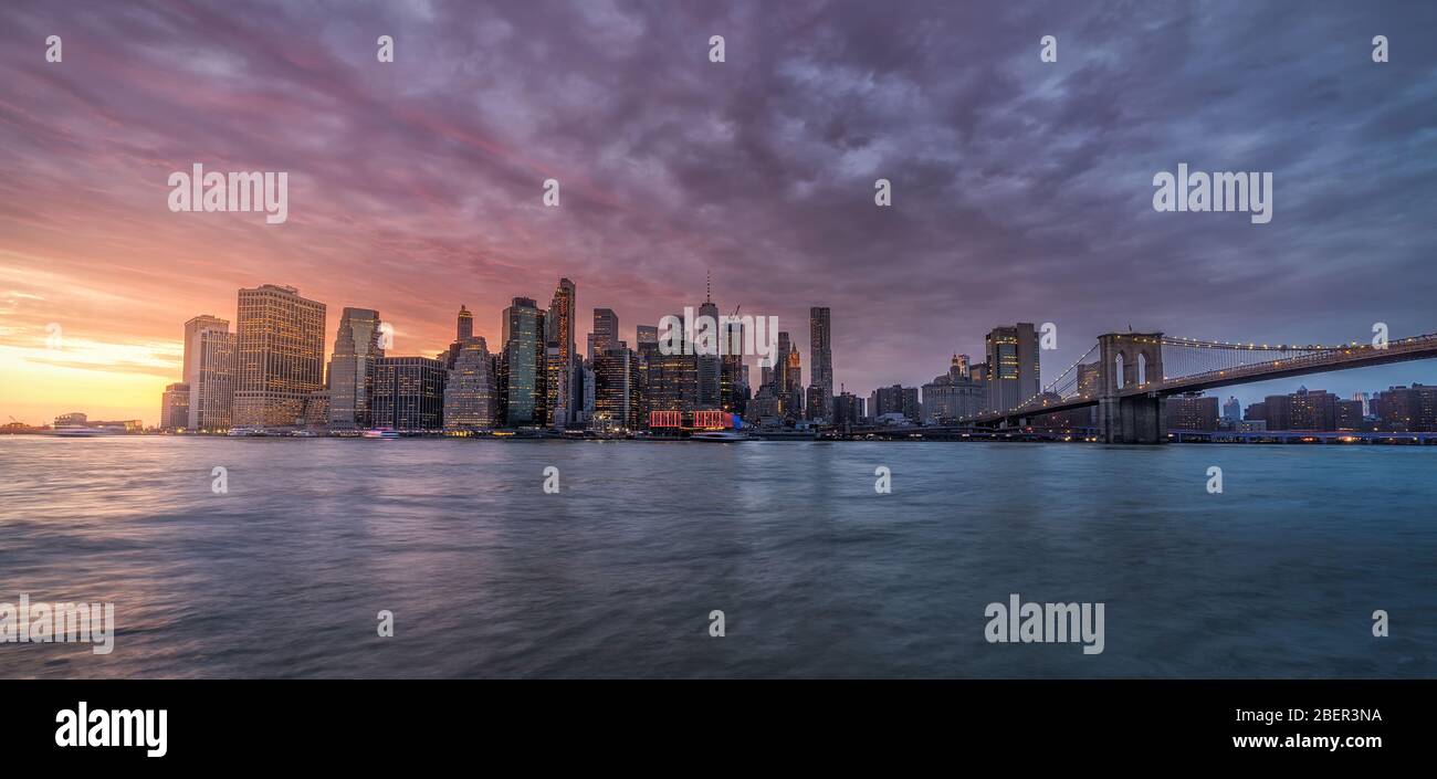 New york skyline reflection on the Hudson river at Brooklyn bridge at ...