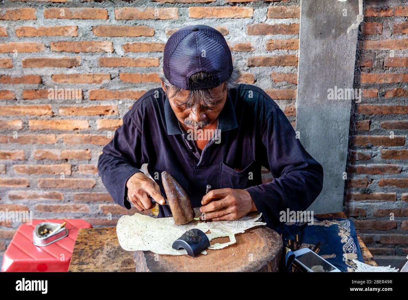A Traditional Leather Shadow Puppet Maker, Yogyakarta, Java, Indonesia. Stock Photo