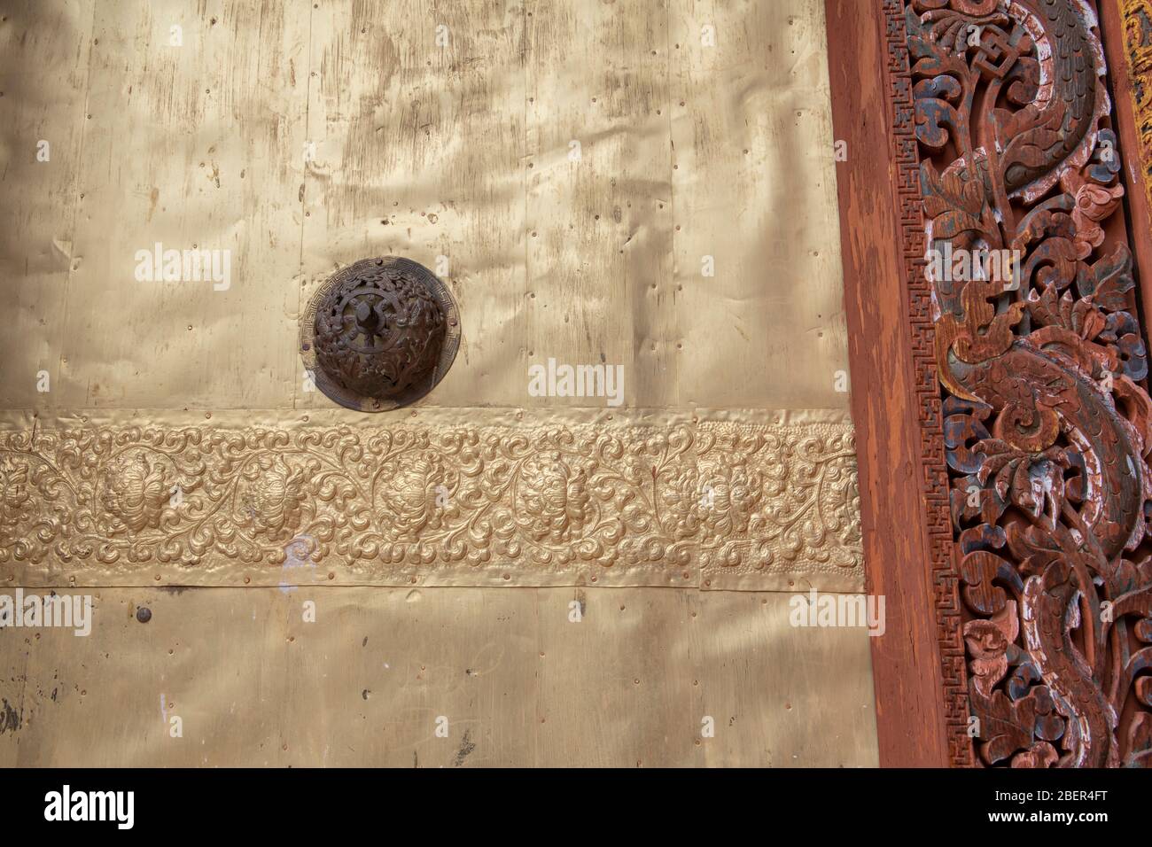 Bhutan, Punakha Dzong. Traditional architecture within the courtyard. Detail of ornate door. Stock Photo