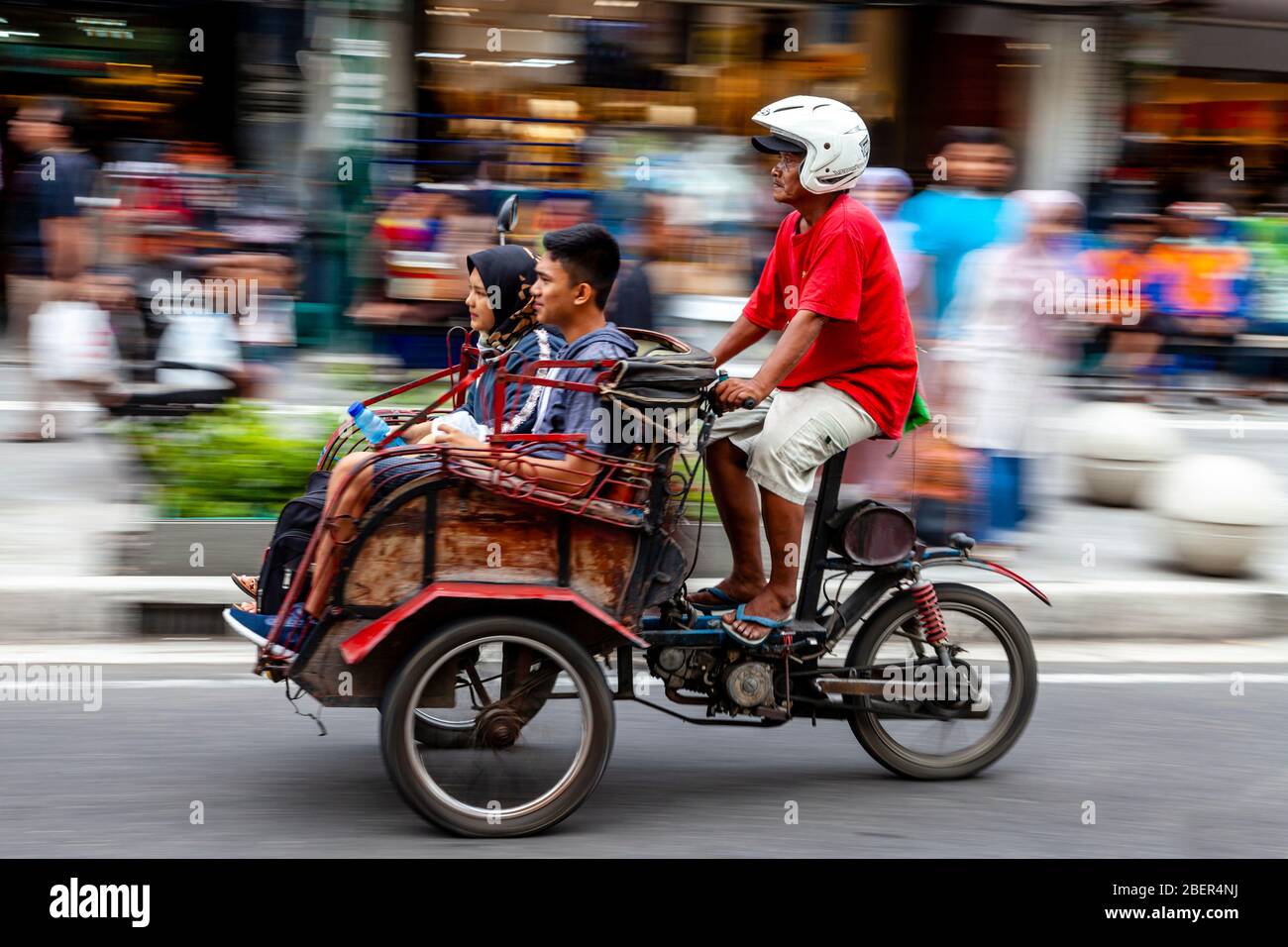 A Motorcycle Taxi and Passengers, Malioboro Street, Yogyakarta, Indonesia. Stock Photo