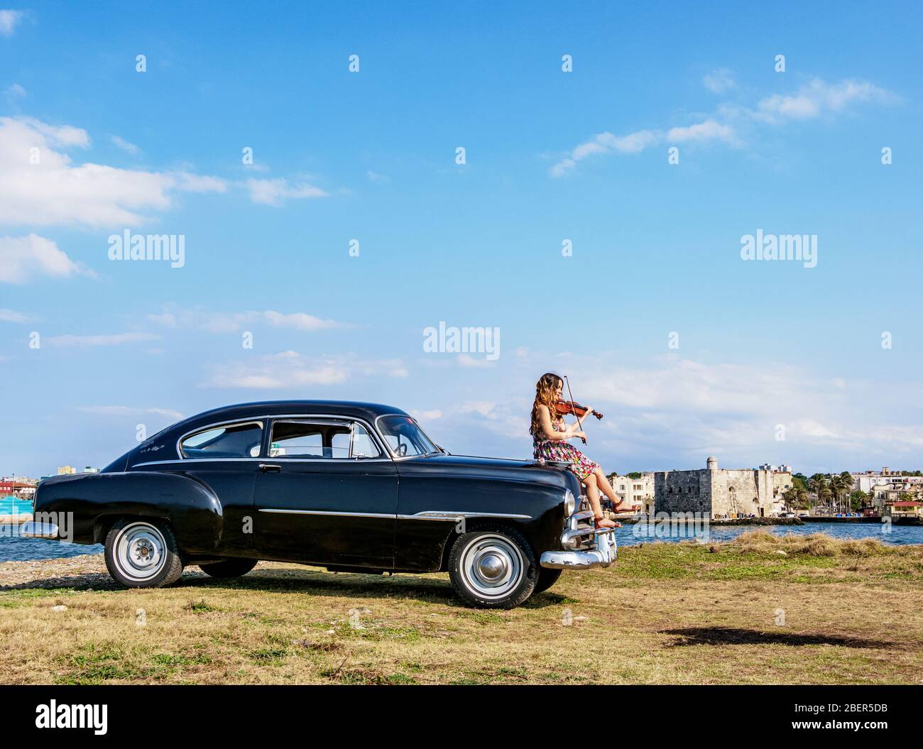 Cuban Violinist at Vintage Chevrolet Car, Havana, La Habana Province, Cuba (MR) Stock Photo