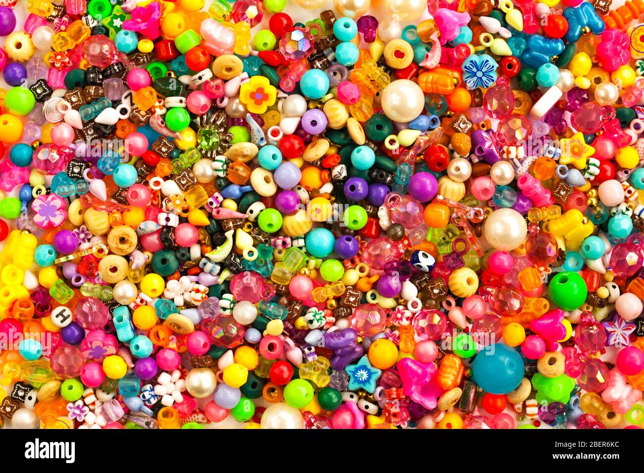 Multicolored beads background. Mix of shiny different size, shape jewelry glass and plastic bead. Stock Photo