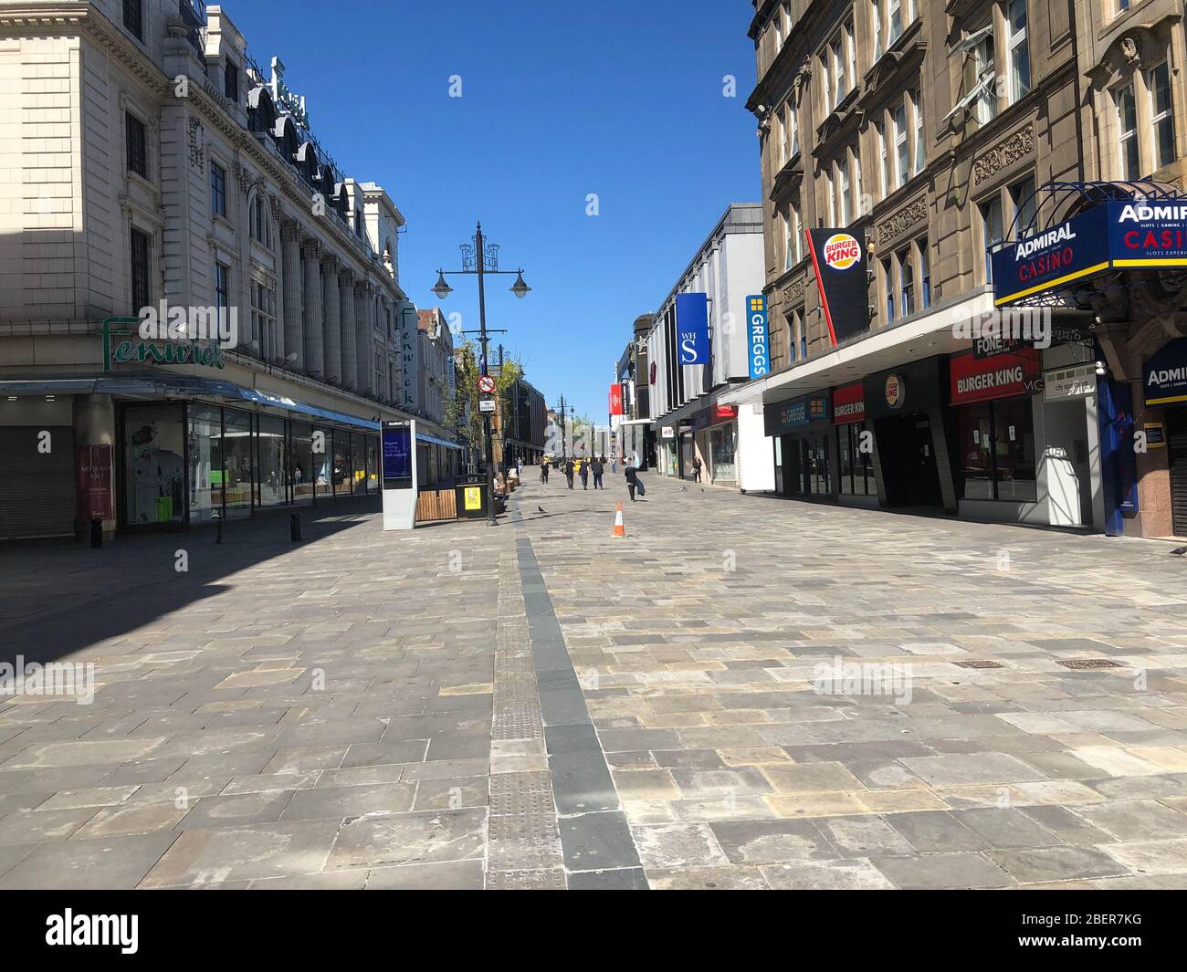 Newcastle upon Tyne, UK.  15 April, 2020.   An unusually quiet Northumberland Street, Newcastle upon Tyne during the Coronavirus Covid19 lockdown/social-distancing period.  Most people continue to respect the government dictate to socially distance.  Victor W. Adams / Alamy Live News Stock Photo