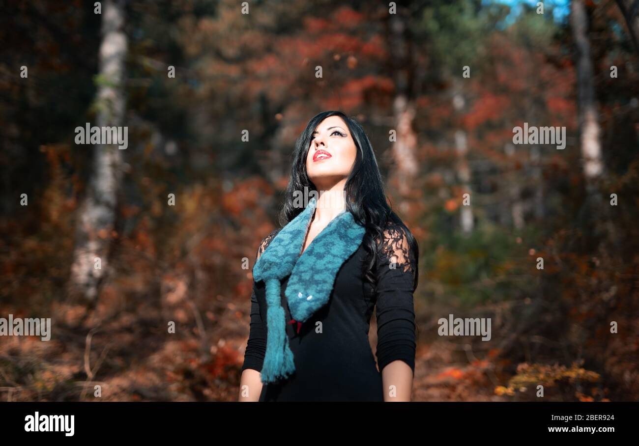 Fashion Portrait of young woman in a forest stay like eva in eden whit a snake Stock Photo