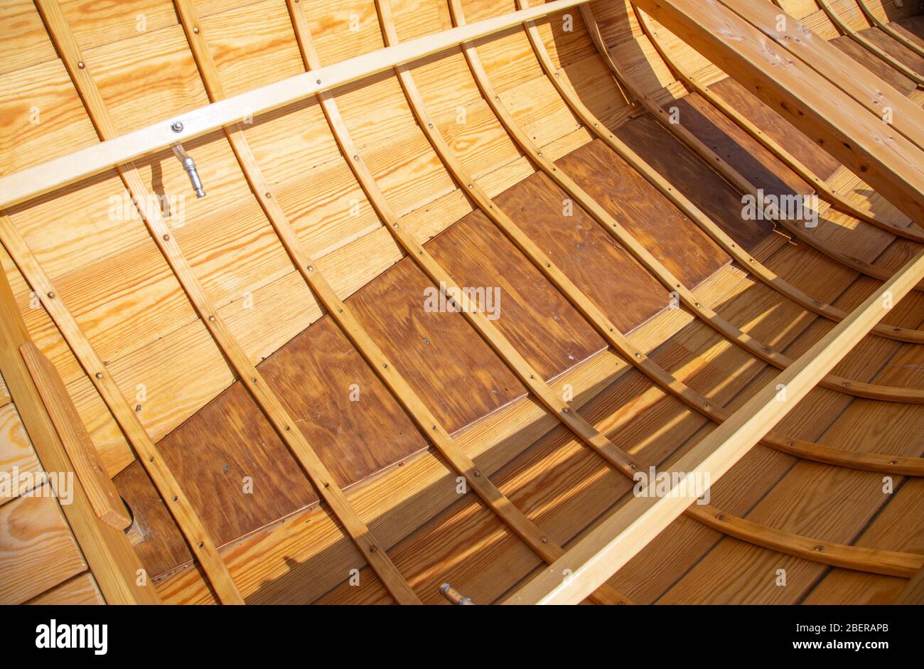 The structure of a wooden handmade rowboat / skiff / dinghy inside bottom and hull . boards nailed to wooden ribs and bottom protected with plywood , Stock Photo