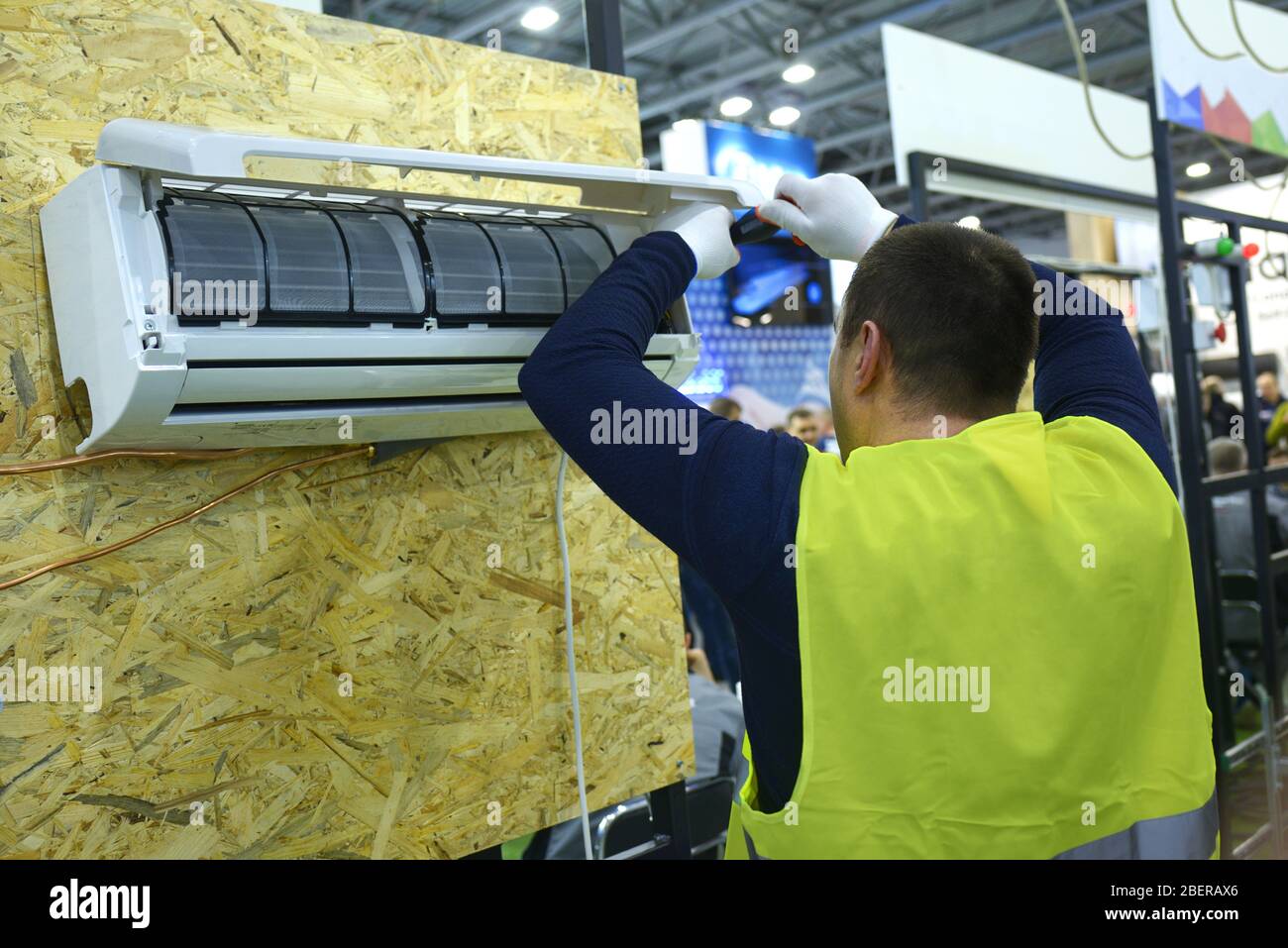 Male fitter assembling air conditioner using screwdriver Stock Photo ...