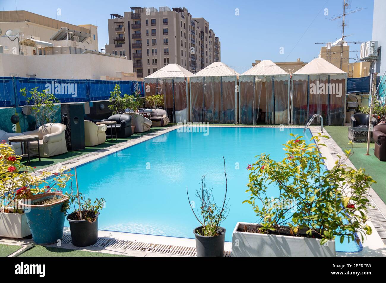 An empty blue tile rooftop pool for a budget city hotel Stock Photo - Alamy