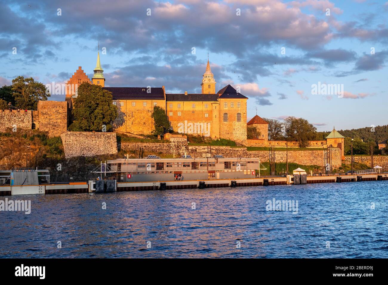 Oslo, Ostlandet / Norway - 2019/09/02: Sunset view of medieval Akershus Fortress - Akershus Festning - historic royal residence at Oslofjorden sea sho Stock Photo