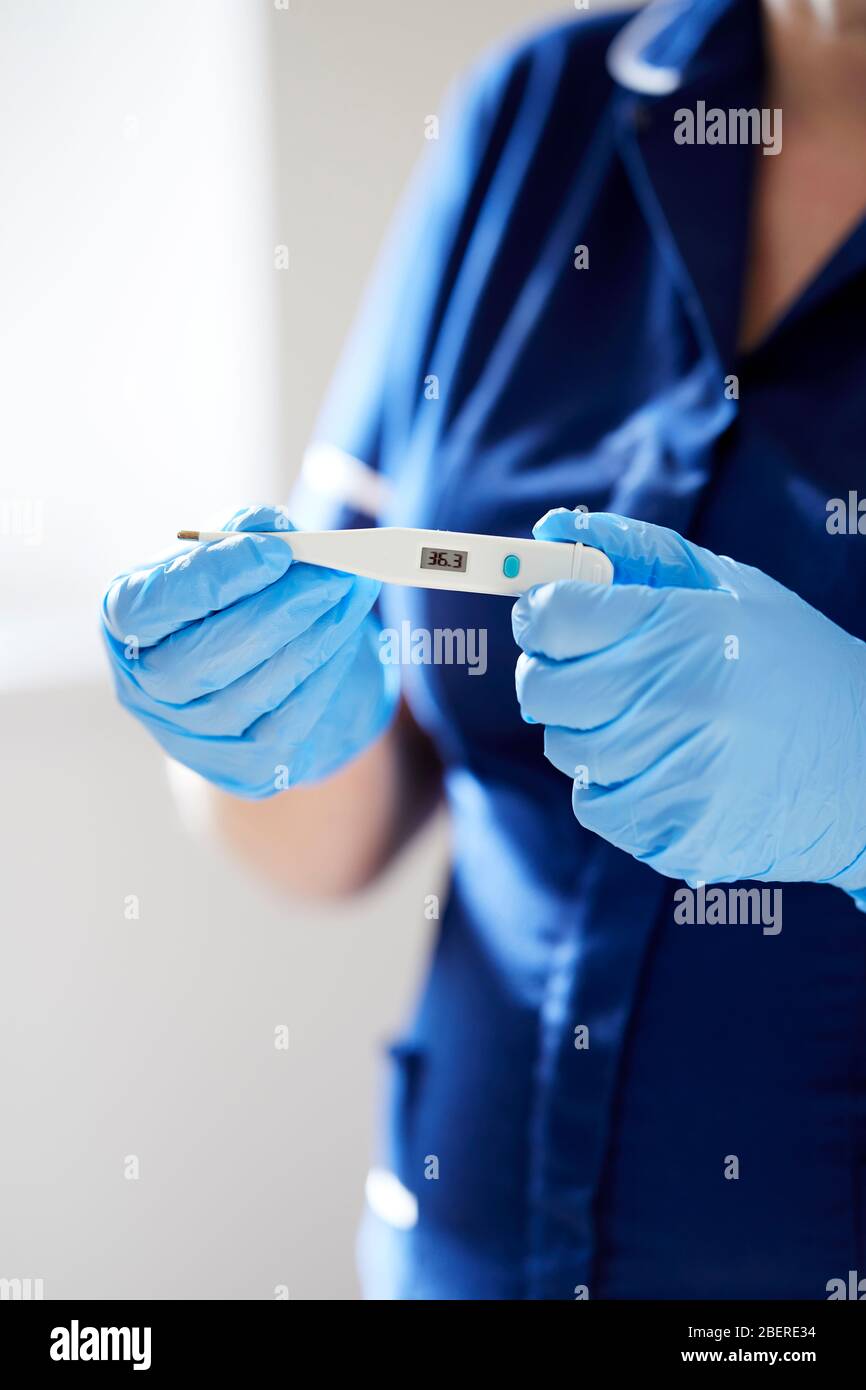 Nurse holding thermometer Stock Photo