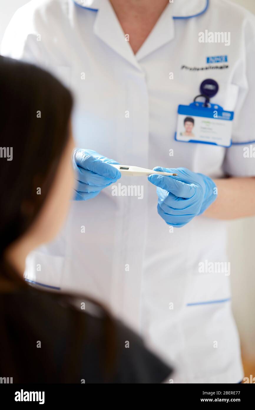 Nurse holding thermometer Stock Photo