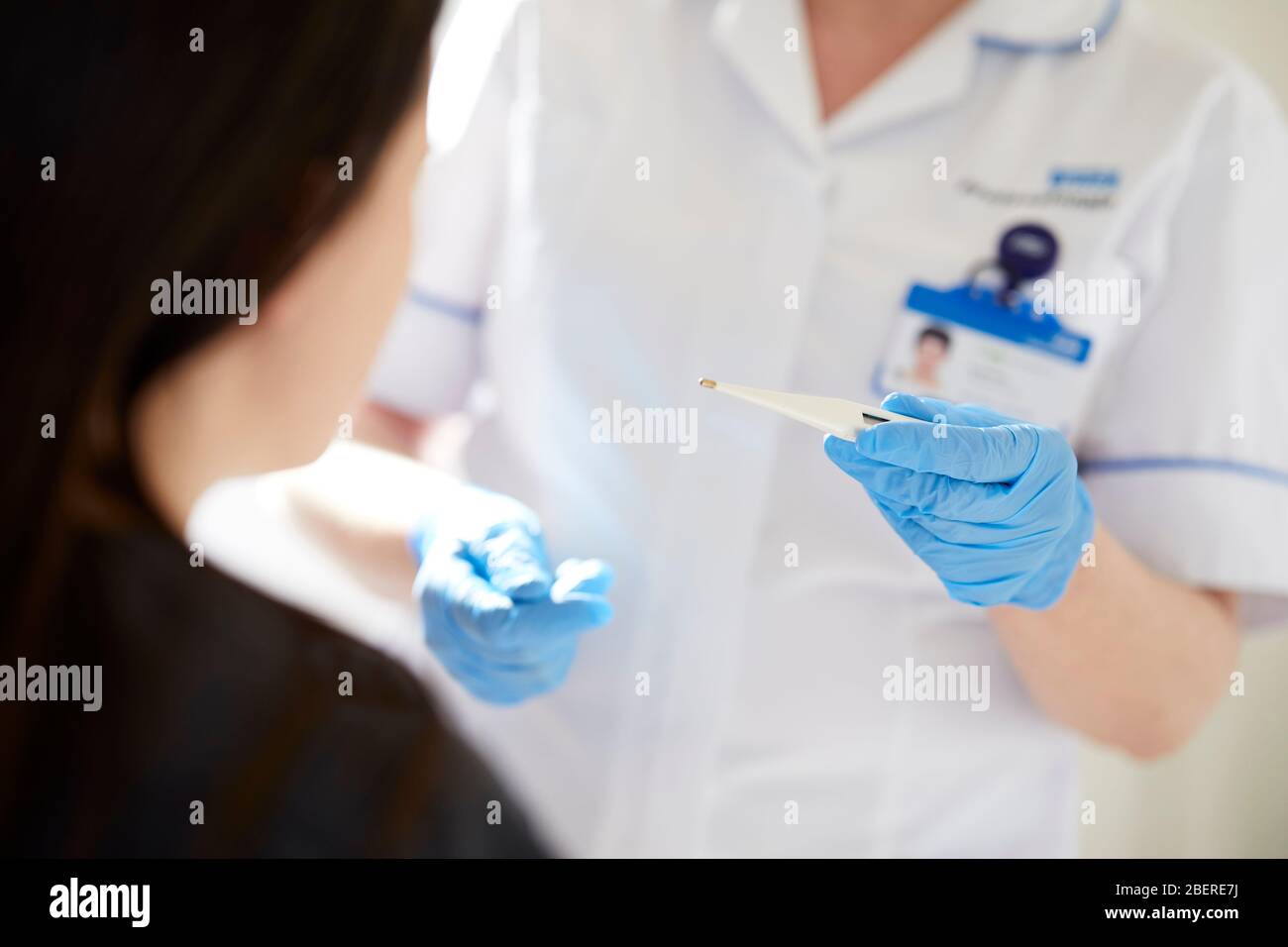 Nurse holding thermometer Stock Photo